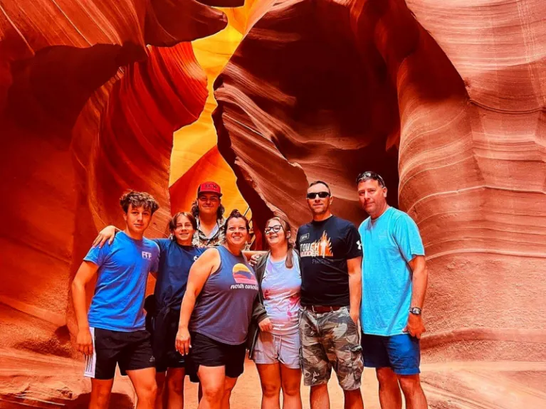 Group posing for photo inside Lower Antelope Canyon